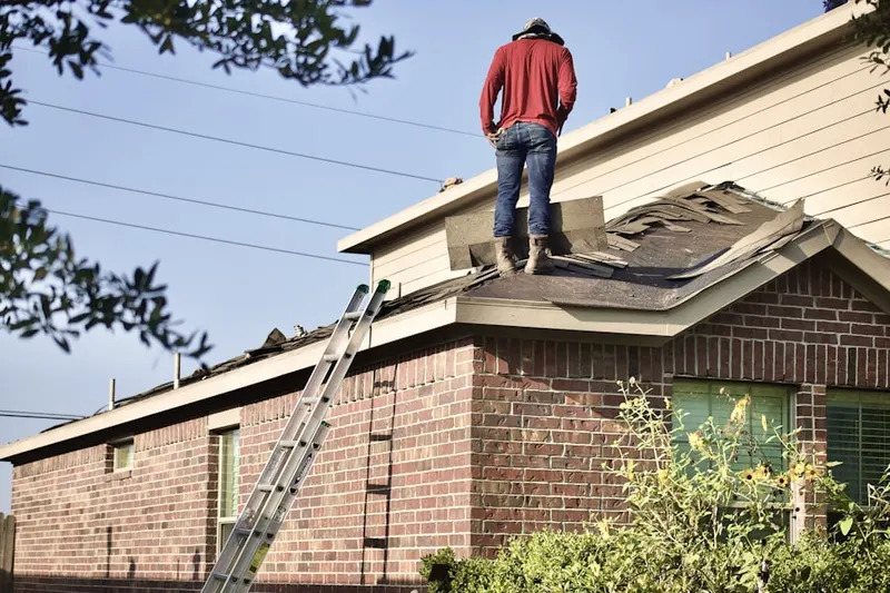 Professional roofer working on a residential roof in Hunters Hollow North